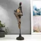 Сувенир интерьерный "Африканка с кувшином в наряде - геометрия, на стуле" 43x11x9.3 см