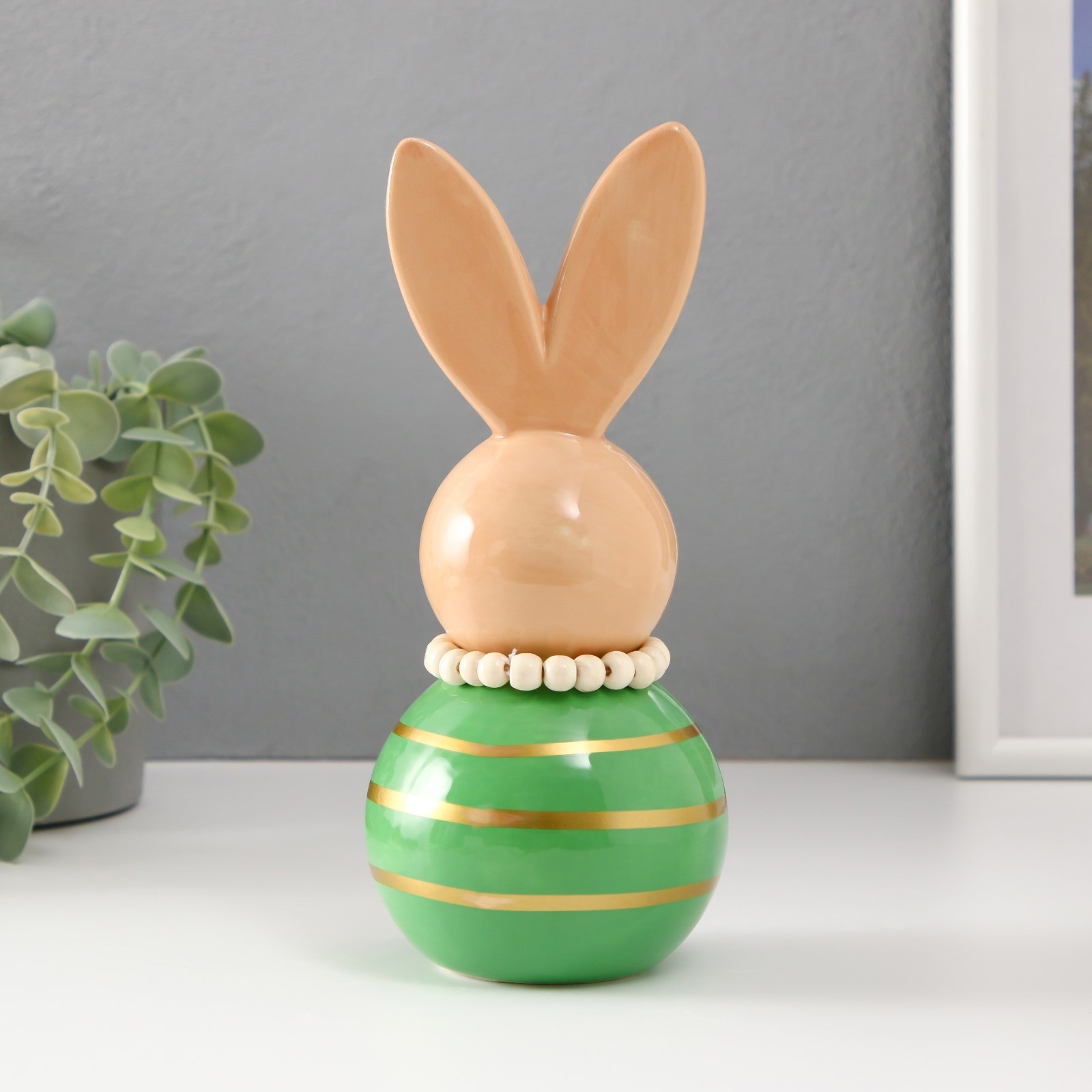 Изображение товара Зайка-неваляшка из керамики 8,5x8,5x20 см бежево-зелёная